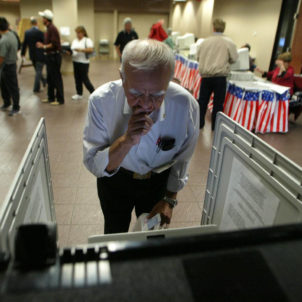 Roberto A. Arreola ponders his choices as he votes Monday, Oct. 18, 2004, at the El Paso County Courthouse in El Paso, Texas. Whether showing support for fellow Texan President Bush or speaking out against Republican redistricting, Texans took advantage of the first day of early voting Monday to cast ballots for the Nov. 2 election. (AP Photo/El Paso Times, Victor Calzada)