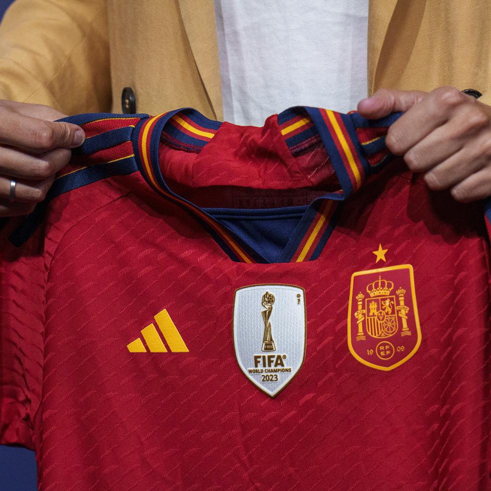 La nueva seleccionadora femenina absoluta de España, Montse Tomé, sostiene una camiseta del equipo en su presentación oficial.