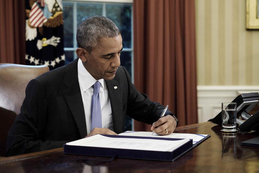 El expresidente Barack Obama firma la ley Promesa el 30 de junio de 2016. (Agencia EFE)