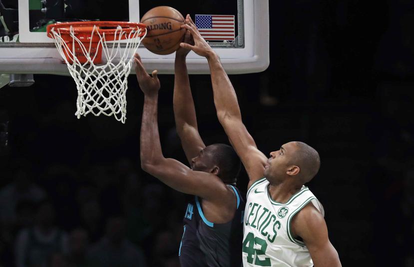 El pívot de los Celtics de Boston Al Horford (42) bloquea un tiro del pívot de los Hornets de Charlotte, durante la primera mitad del partido de la NBA en Boston. (AP)