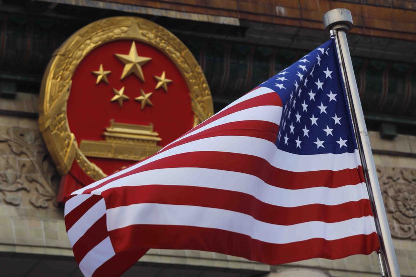 Una bandera estadounidense frente al símbolo patrio chino durante la ceremonia de llegada del presidente estadounidense Donald Trump en Beijing en 2017. (AP)