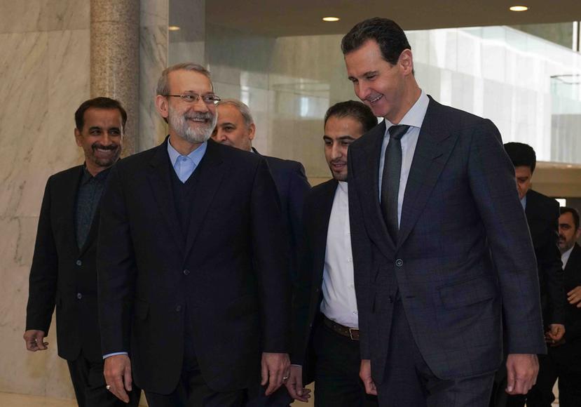El presidente Siria, Bashar Assad (derecha), habla con el presidente del parlamento iraní, Ali Larijani, en Damasco, Siria. (SANA via AP)