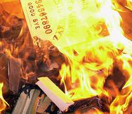 Ouija boards, the works of Shakespeare, "Harry Potter" books, AC/DC records and more burn in a "holy fire" in front of Christ Community Church following the Rev. Jack Brock's sermon Sunday, Dec. 31, 2001, in Alamogordo, N.M. (AP Photo/Alamogordo Daily News, Ellsi Neel)