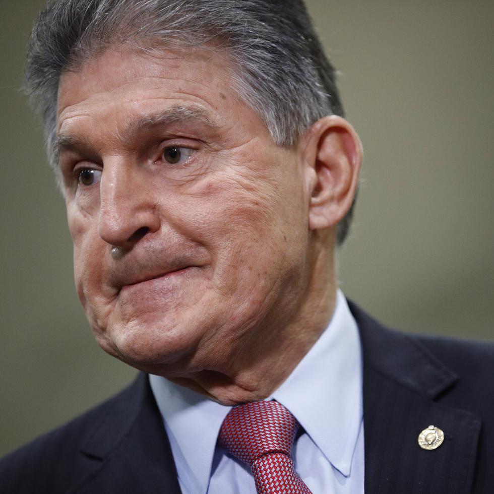 FILE - In this Feb. 5, 2020, file photo, Sen. Joe Manchin, D-W.Va., speaks with reporters on Capitol Hill in Washington. A bipartisan group of lawmakers, including Manchin,  is putting pressure on congressional leaders to accept a split-the-difference solution to the months-long impasse on COVID-19 relief in a last-gasp effort to ship overdue help to a hurting nation before Congress adjourns for the holidays. (AP Photo/Patrick Semansky, File)