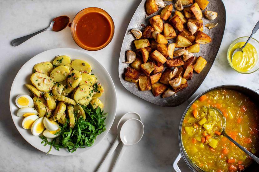 De izquierda a derecha, ensalada de papas con alcaparras y anchoas, patatas bravas fritas al horno con dos salsas y sopa de papa con especias indias en Nueva York, el 25 de abril de 2020. (Andrew Scrivani/The New York Times)