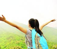 cheering hiking woman open arms at mountain peak
-----
