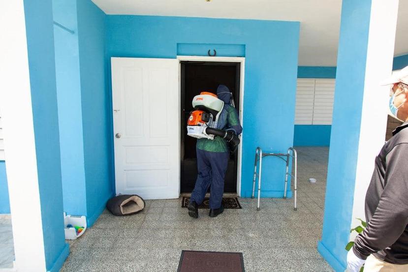 Un empleado del municipio desinfecta una residencia. (Suministrada)