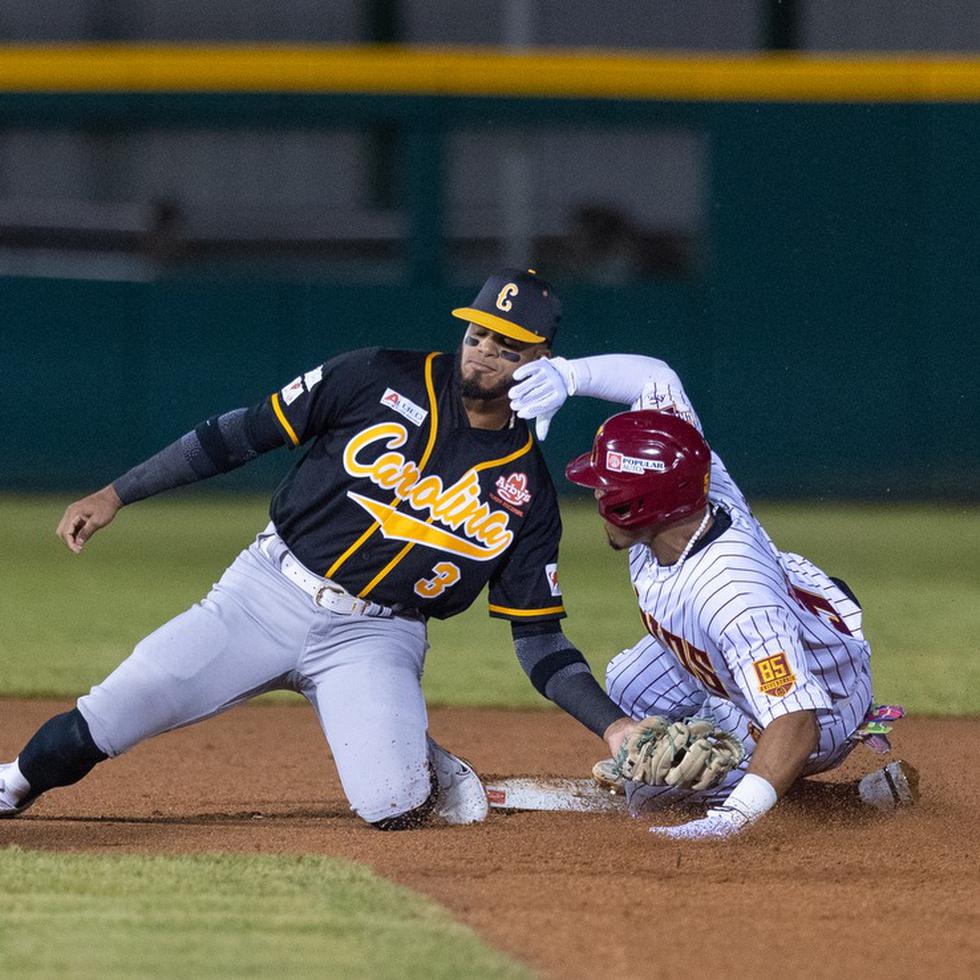 El campocorto de los Gigantes de Carolina, Delvin Pérez, realiza una jugada de out en segunda base contra los Indios de Mayagüez durante el partido inaugural de la temporada 2023-24 del béisbol invernal.