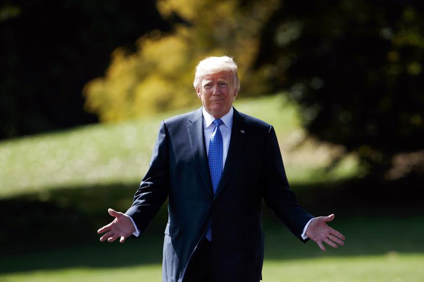 President Donald Trump walks to speak to reporters as he walks to board Marine One on the South Lawn of the White House.