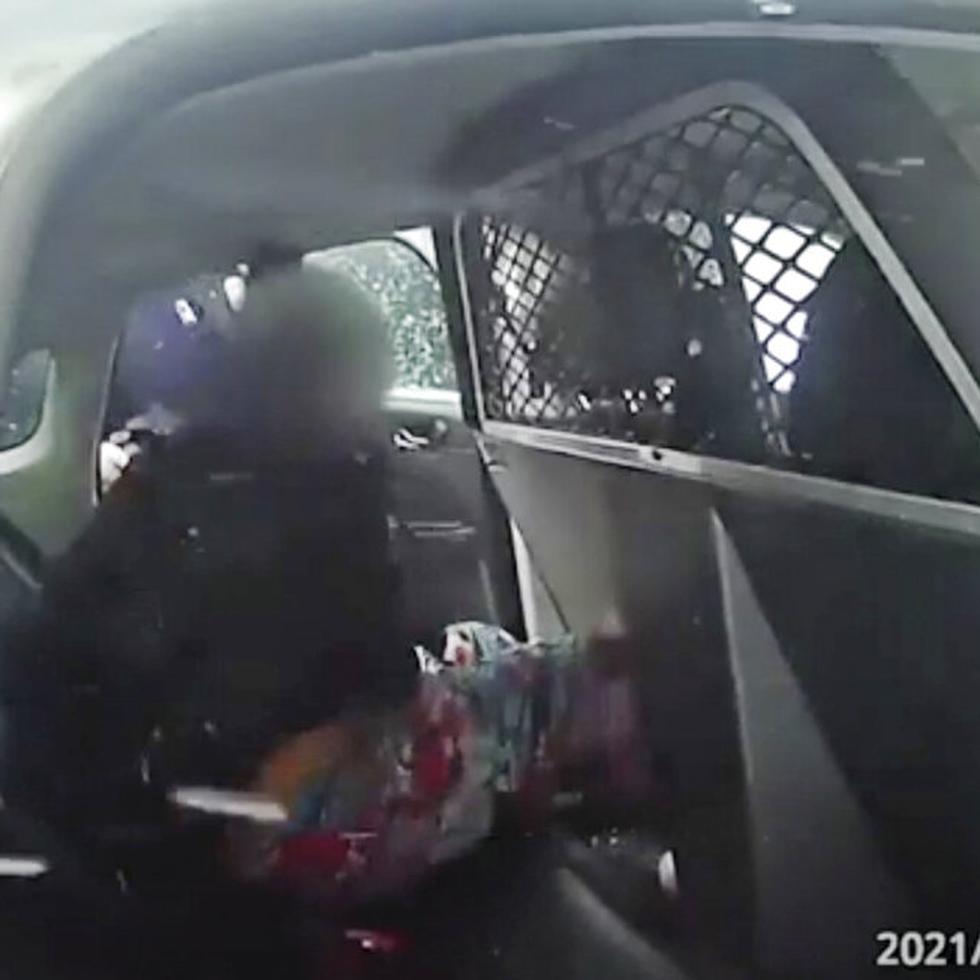 In this this Jan. 29. 2021 still frame from a Rochester Police Department body-camera video, a nine-year-old girl is handcuffed in police custody in a police cruiser after police used pepper spray on her as she screamed for her father. Rochester, New York police released two body-camera videos of officers restraining the girl. According a local news outlet, Rochester Mayor Lovely Warren expressed her concern for the child.