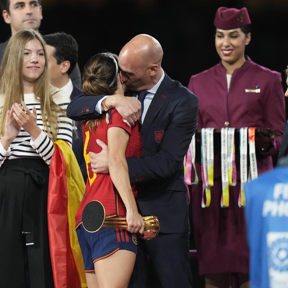 El presidente de la federación española de fútbol, Luis Rubiales (derecha), abraza a la volante Aitana Bonmatí en el podio tras la victoria de España ante Inglaterra en la final del Mundial femenino.