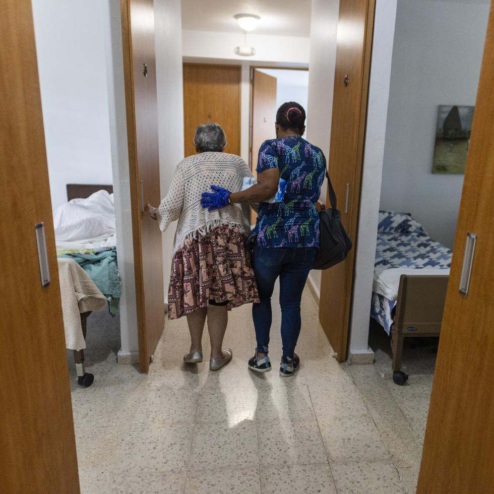 El Hogar Loma San Agustín, en San Juan, está adaptado para el cuidado de adultos mayores. En la foto, una enfermera asiste a una anciana a ir al baño y se muestra la amplitud de los pasillos.