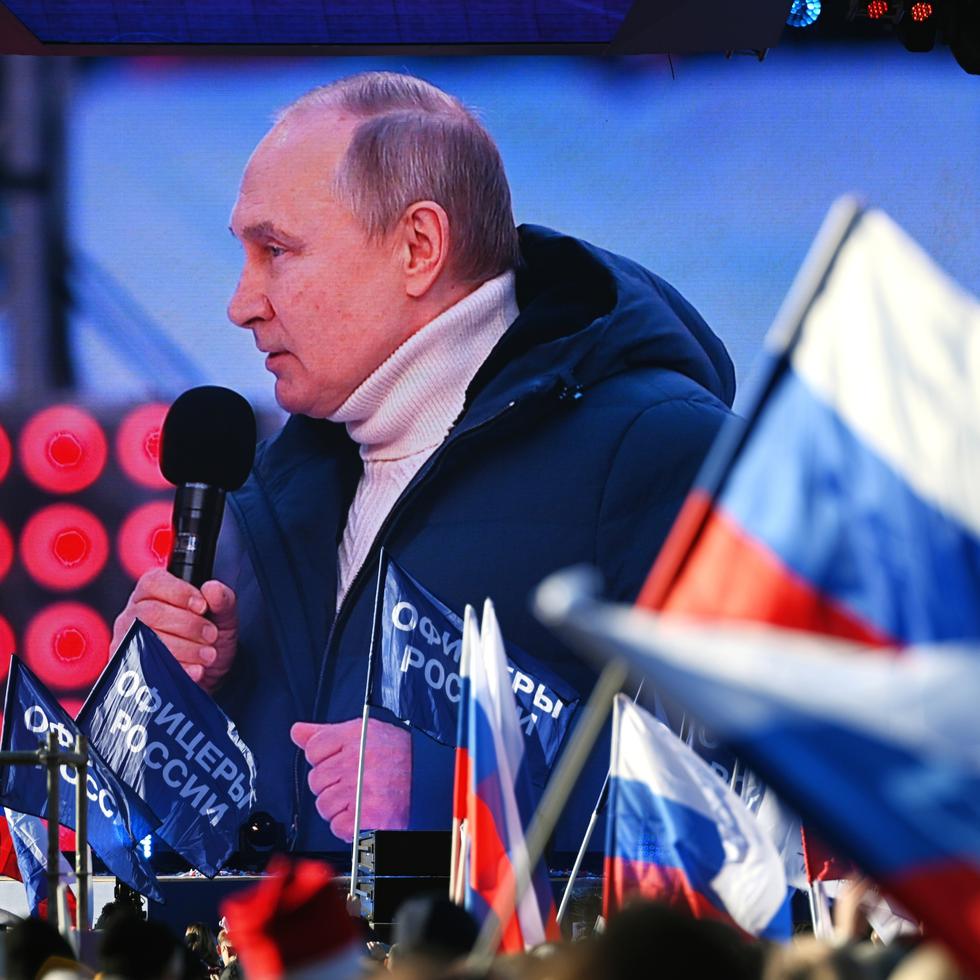 FILE - Russian President Vladimir Putin is displayed on a big screen as he delivers his speech at the concert marking the eighth anniversary of the referendum on the state status of Crimea and Sevastopol and its reunification with Russia, in Moscow, Russia, March 18, 2022. (Vladimir Astapkovich/Sputnik Pool Photo via AP, File)