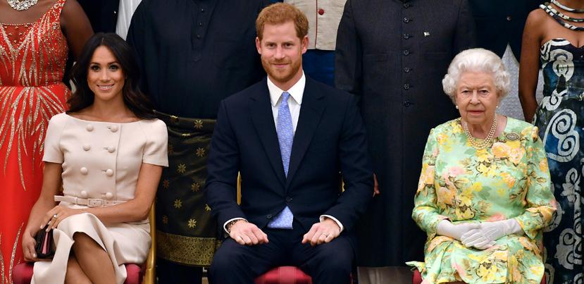 Meghan Markle, el príncipe Harry y la reina Elizabeth II durante la entrega de los Premios a los Jóvenes Líderes de la Reina en el Palacio de Buckingham. (AP)