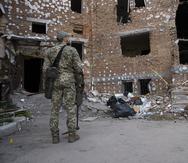 Un soldado ucraniano inspecciona daños por los ataques de las fuerzas rusas.