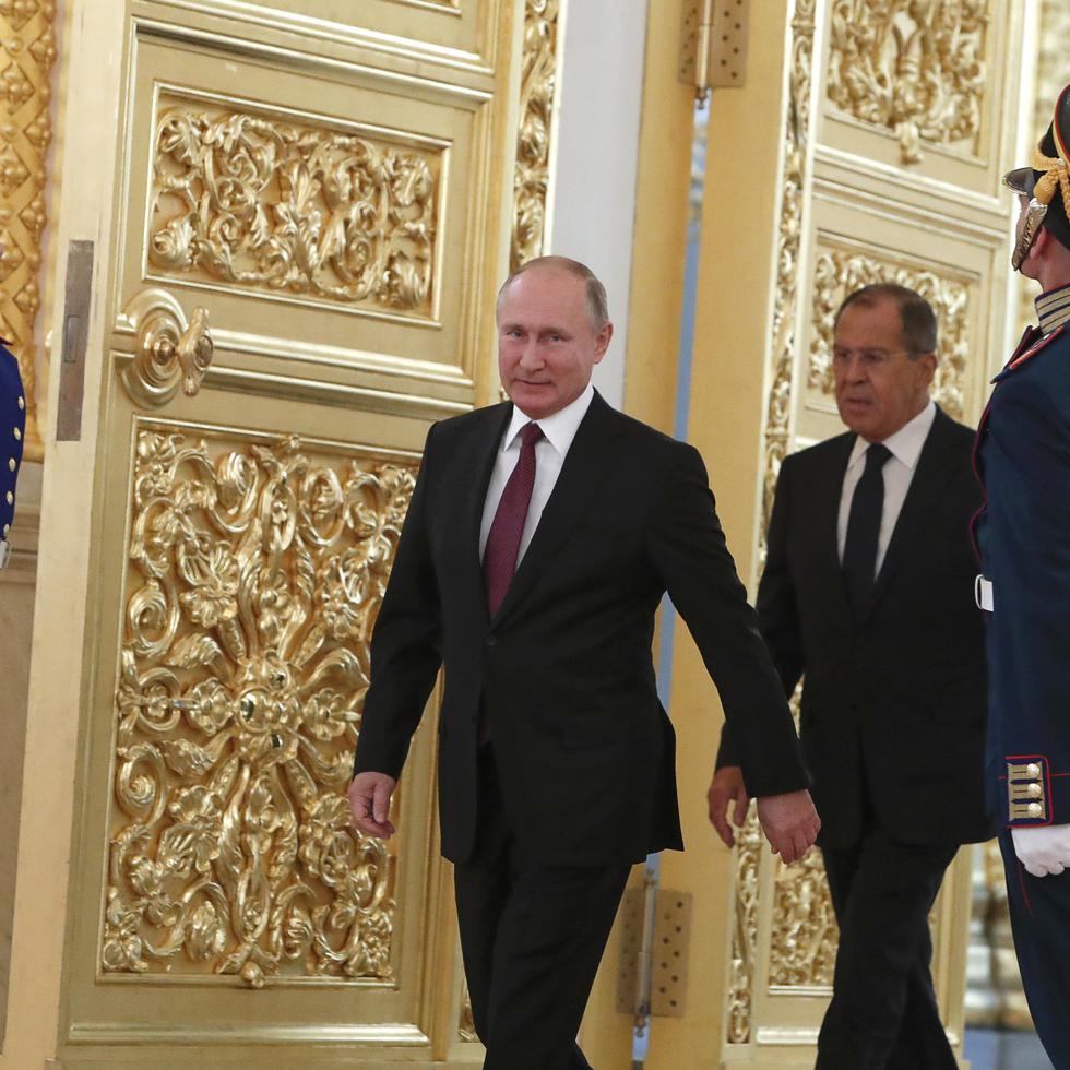 FILE - Russian President Vladimir Putin and Foreign Minister Sergei Lavrov walk past honour guards as they attend a ceremony to receive diplomatic credentials from newly appointed foreign ambassadors at the Kremlin in Moscow, Russia, Thursday, Oct. 11, 2018. In the wake of the 2022 invasion of Ukraine, U.S. sanctions are targeting Putin and a handful of individuals believed to be among his closest security advisers, including Lavrov. (Sergei Karpukhin/Pool Photo via AP, File)