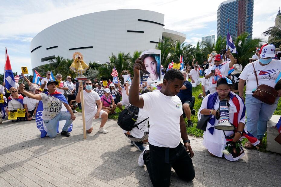 Some protesters knelt to pray as they gathered to support the protests in Cuba.