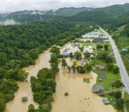 Home and structures are flooded near Quicksand, Ky., Thursday, July 28, 2022. Heavy rains have caused flash flooding and mudslides as storms pound parts of central Appalachia. Kentucky Gov. Andy Beshear says it's some of the worst flooding in state history. (Ryan C. Hermens/Lexington Herald-Leader via AP)
