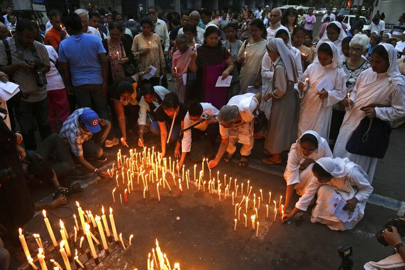 Algunas personas encienden velas para conmemorar a las personas que murieron en los ataques terroristas del Domingo de Pascua en Sri Lanka. (AP)