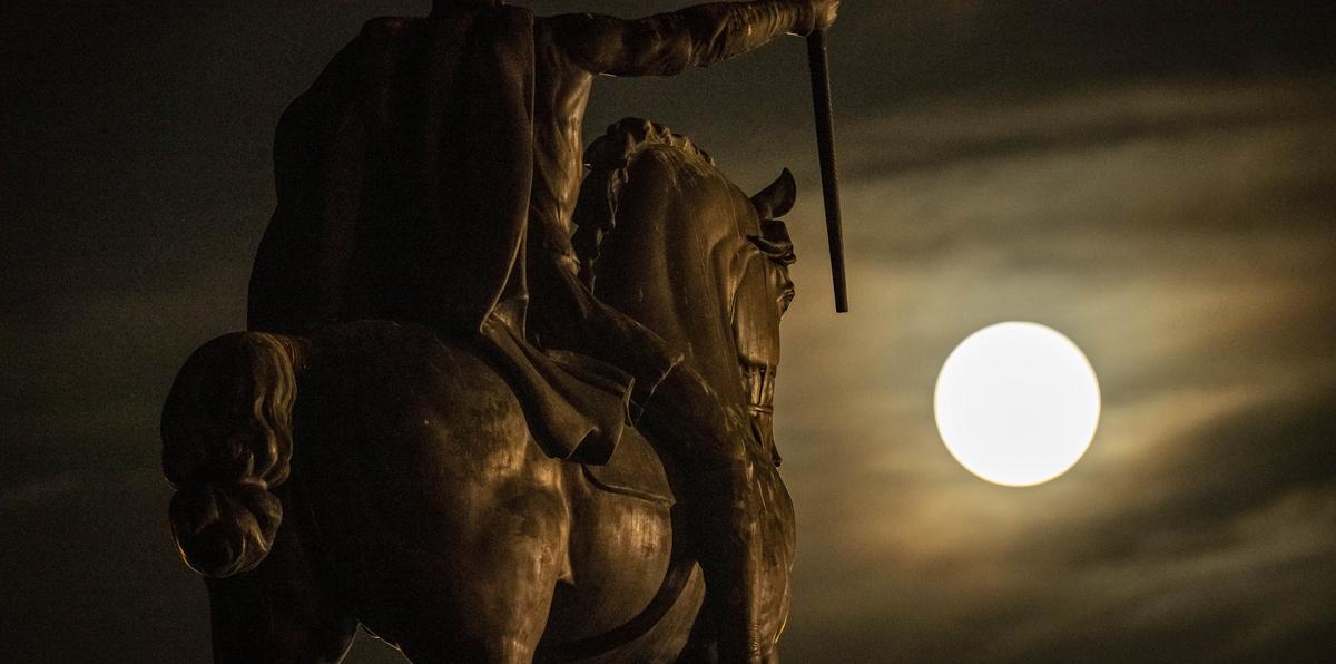 Una superluna se eleva detrás de la escultura de Tomislav de Croacia, el primer rey croata, en el centro de Zagreb, Croacia.