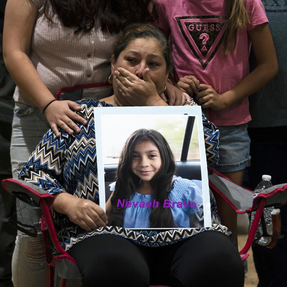 Esmeralda Bravo, 63, sheds tears while holding a photo of her granddaughter, Nevaeh, one of the Robb Elementary School shooting victims, during a prayer vigil in Uvalde, Texas, Wednesday, May 25, 2022. (AP Photo/Jae C. Hong)