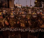 Policías antidisturbios enfrentaban a los manifestantes ayer, sábado, en el centro de Lima (Perú). Una reportera y un fotoperiodista fueron agredidos por la Policía este sábado mientras cubrían una marcha antigubernamental en Lima, donde los agentes también "restringieron" la cobertura de un equipo de prensa que registraba "excesos" policiales, denunció la Asociación Nacional de Periodistas del Perú.