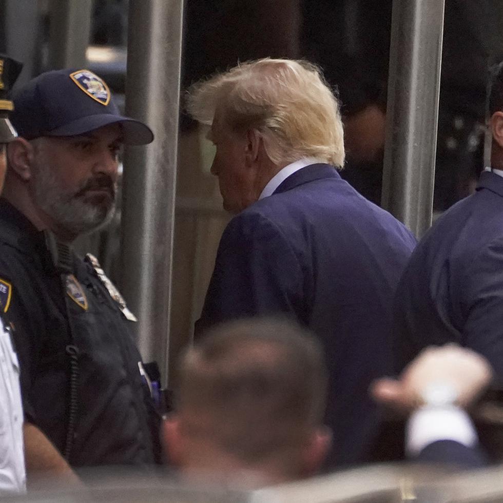 Former President Donald Trump arrives at the Manhattan District Attorney's office, Tuesday, April 4, 2023, in New York. Trump is set to appear in a New York City courtroom on charges related to falsifying business records in a hush money investigation, the first president ever to be charged with a crime. (AP Photo/John Minchillo)
