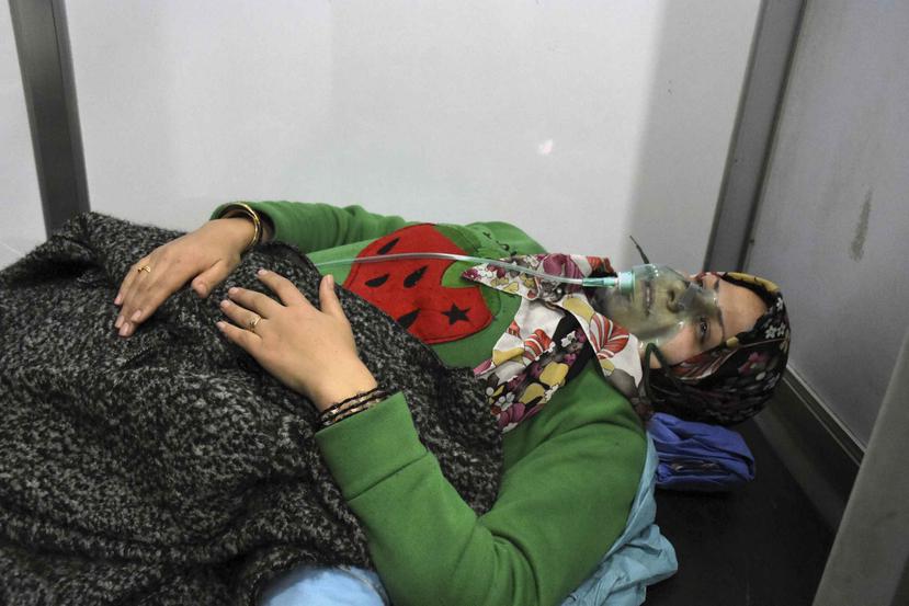 En esta imagen difundida por la agencia noticiosa oficial siria SANA, se ve a una mujer recibiendo oxígeno a través de una mascarilla después de un supuesto ataque químico en su localidad de al-Khalidiya, en Alepo, Siria, el sábado 25 de noviembre de 2018