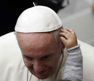 El papa Francisco es acariciado por un niño en el aula Pablo VI en el Vaticano, domingo 16 de diciembre de 2018. (AP)