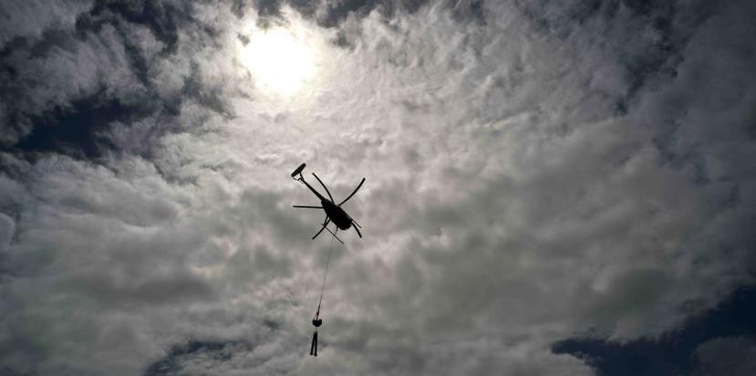 A helicopter of Whitefish Energy Holdings flies to a place where repairs will be made on power lines after Maria. (AP)