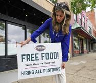 Coleen Piteo, director of marketing at Yours Truly restaurant, puts out a sign for hiring, Thursday, June 3, 2021, in Chagrin Falls, Ohio. The number of Americans seeking unemployment benefits fell last week for a fifth straight week to a new pandemic low, the latest evidence that the U.S. job market is regaining its health as the economy further reopens. (AP Photo/Tony Dejak)