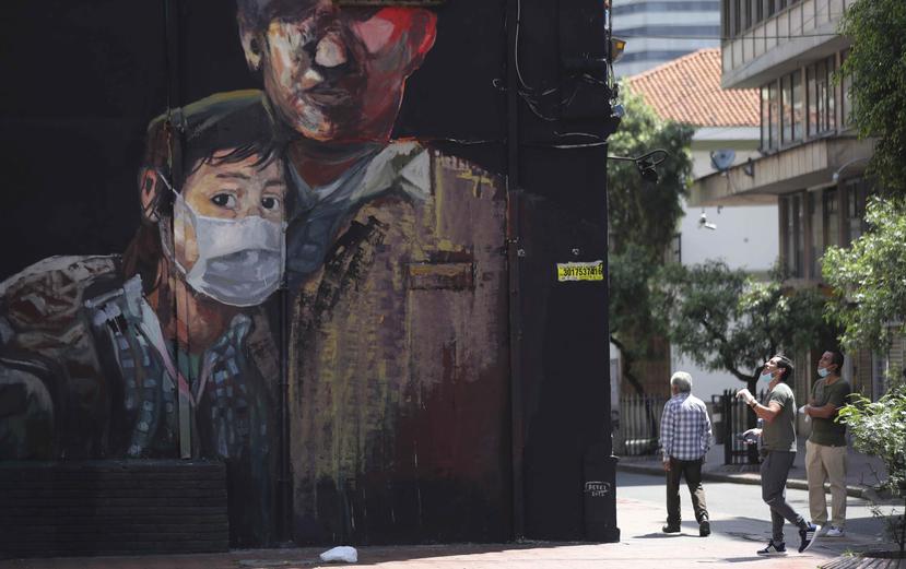 Un mural pintado recientemente muestra a un joven usando una máscara durante una cuarentena ordenada por el gobierno para evitar contagios por el coronavirus en Bogotá, Colombia, el lunes 13 de abril de 2020.