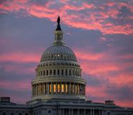 FILE - In this Thursday, Nov. 30, 2017, file photo, the sky over The Capitol is lit up at dawn as Senate Republicans work to pass their sweeping tax bill this week in Washington, (AP Photo/J. Scott Applewhite)