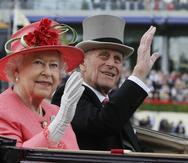FILE - In this Thursday June, 16, 2011 file photo Britain's Queen Elizabeth II with Prince Philip arrive by horse drawn carriage in the parade ring on the third day, traditionally known as Ladies Day, of the Royal Ascot horse race meeting at Ascot, England. Buckingham Palace says Prince Philip, husband of Queen Elizabeth II, has died aged 99. (AP Photo/Alastair Grant, File)