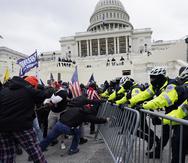 Trump supporters try to break through a police barrier, Wednesday, Jan. 6, 2021, at the Capitol in Washington. (AP Photo/Julio Cortez)