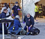 Paramédicos asisten a una persona que resultó herida luego que una SUV se estrelló contra una tienda de Apple en Massachusetts.