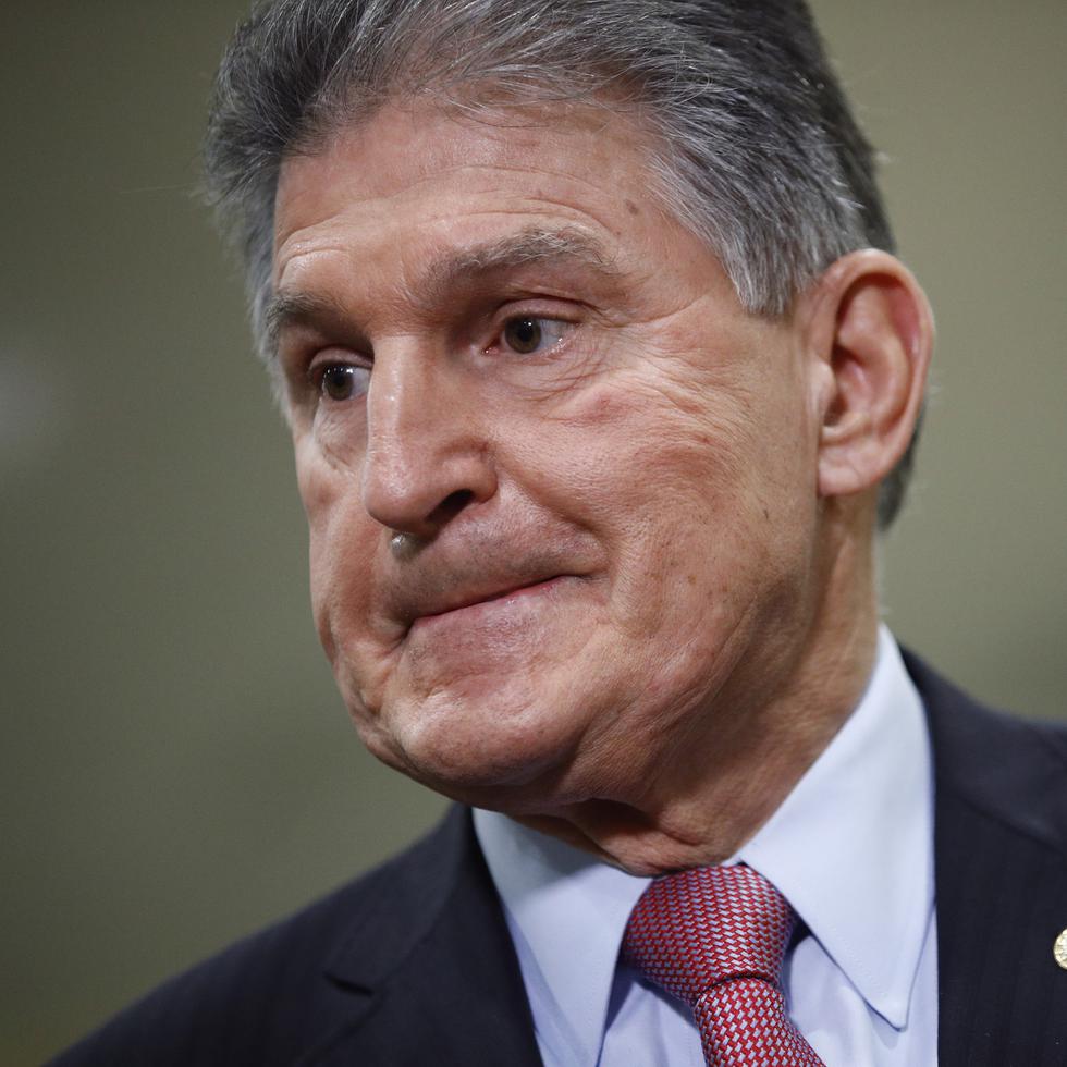 FILE - In this Feb. 5, 2020, file photo, Sen. Joe Manchin, D-W.Va., speaks with reporters on Capitol Hill in Washington. A bipartisan group of lawmakers, including Manchin,  is putting pressure on congressional leaders to accept a split-the-difference solution to the months-long impasse on COVID-19 relief in a last-gasp effort to ship overdue help to a hurting nation before Congress adjourns for the holidays. (AP Photo/Patrick Semansky, File)