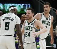 Pat Connaughton y Bobby Portis, de los Bucks de Milwaukee, festejan la victoria en el tercer partido de la semifinal de la Conferencia Este ante los Celtics de Boston.