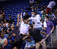 Imágenes de fanáticos, algunos con mascarillas y otros no, durante un partido de los Cangrejeros de Santurce en el Coliseo de Puerto Rico.