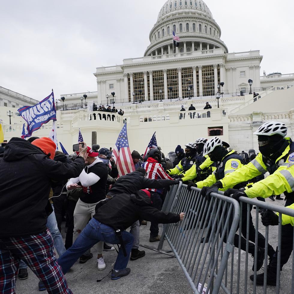 Trump supporters try to break through a police barrier, Wednesday, Jan. 6, 2021, at the Capitol in Washington. (AP Photo/Julio Cortez)