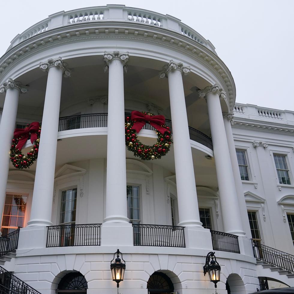 Wreaths hang on the Truman Balcony of the White House in Washington, Sunday, Nov. 27, 2022. (AP Photo/Susan Walsh)
