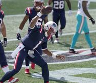 Cam Newton, 'quarterback' de los Patriots de New England, celebra lanzando el balón luego de anotar un 'touchdown' por tierra.