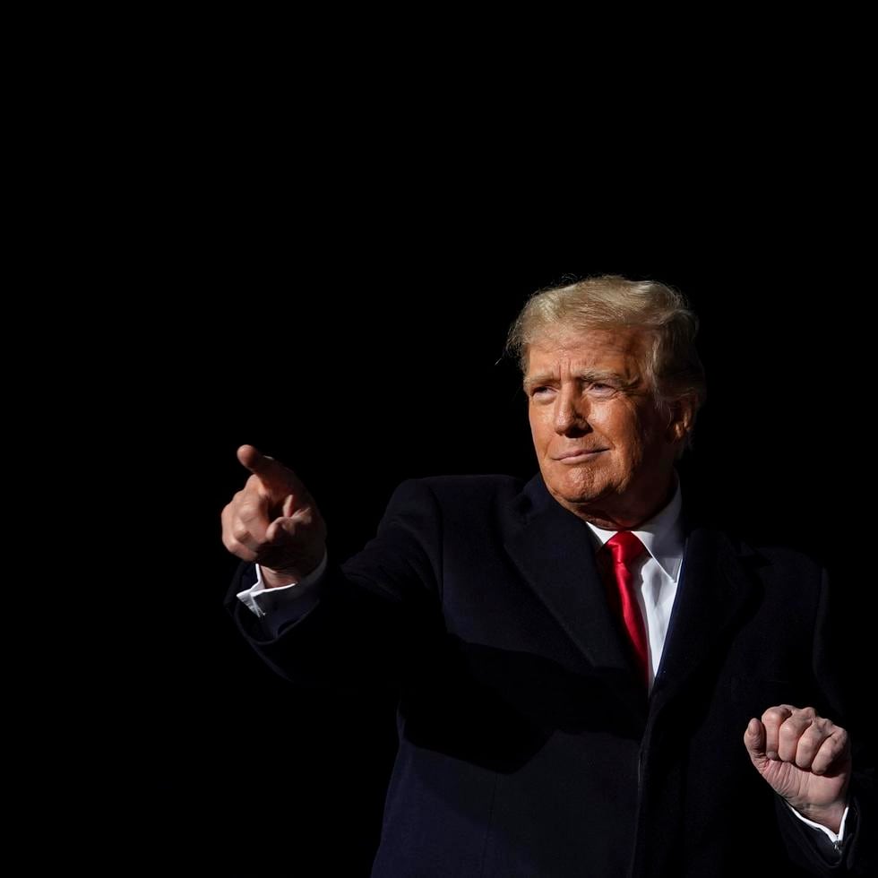 Former President Donald Trump dances after he finished speaking at a campaign rally in support of the campaign of Ohio Senate candidate JD Vance at Wright Bros. Aero Inc. at Dayton International Airport on Monday, Nov. 7, 2022, in Vandalia, Ohio. (AP Photo/Michael Conroy)