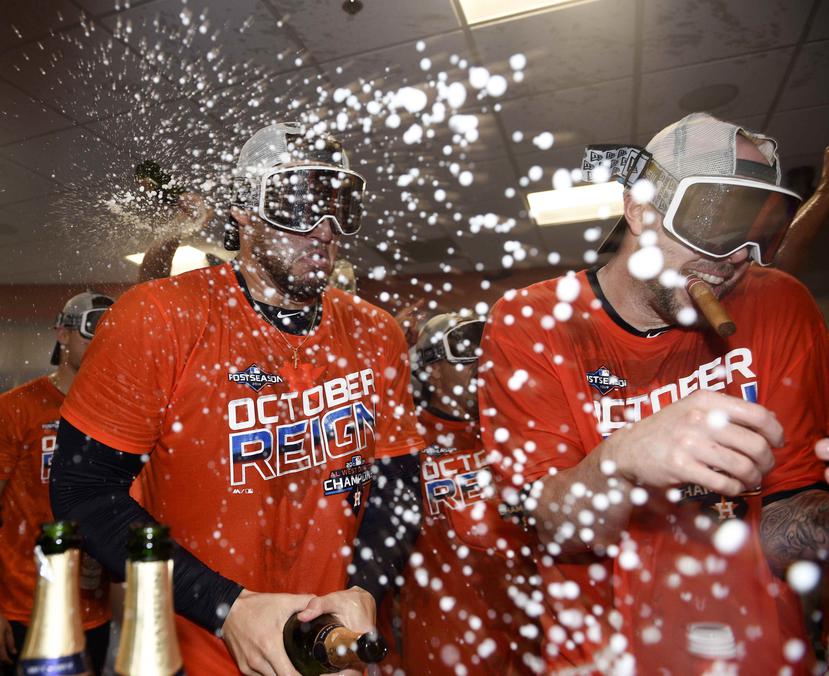 George Springer (izq.) y Ryan Pressly celebran luego que los Astros de Houston capturaron el banderín de la División Oeste de la Liga Americana. (AP / Eric Christian Smith)