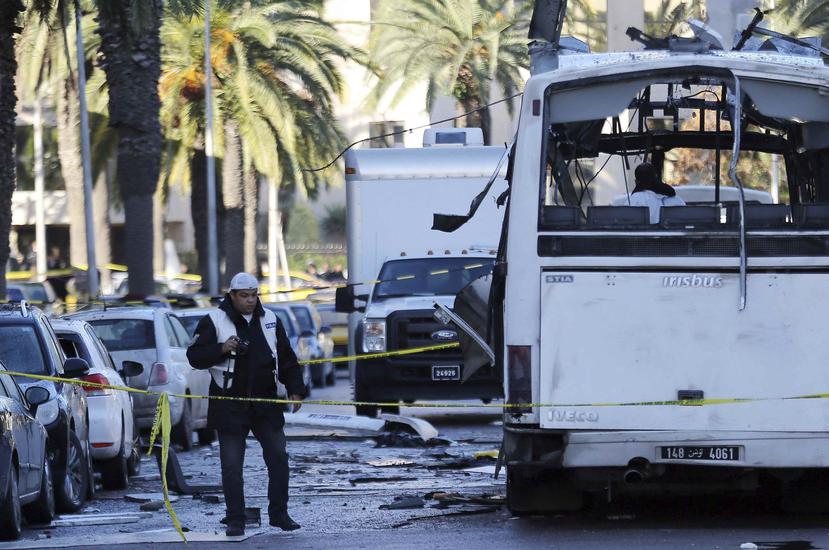 Policías forenses tunecinos inspeccionaron los restos del autobús tras el atentado contra varios guardias presidenciales que se encontraban a bordo del vehículo, en Túnez (Túnez), ayer. (EFE)