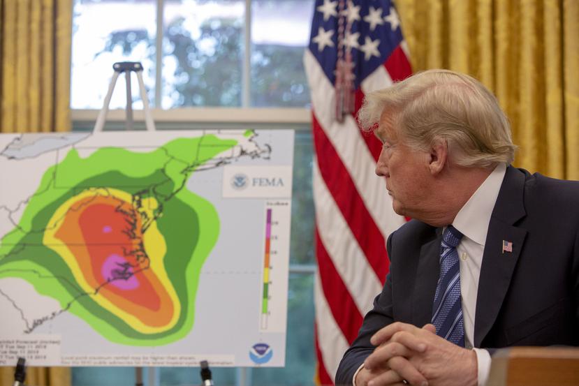 Trump observa un mapa del posible impacto del huracán Florence. (EFE / Tasos Katopodis)