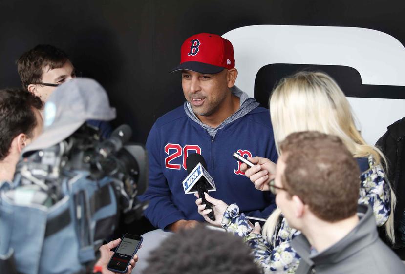 Alex Cora answers questions from reporters before the start of a game. (AP / Jeff Haynes)