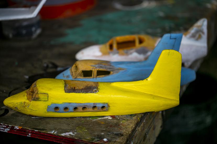 In his carvings, Perfecto Santiago Rosario replicates the colors and details of the planes he sees landing at the airport on the island municipality of Culebra, PR.  Xavier Garcia / Photojournalist