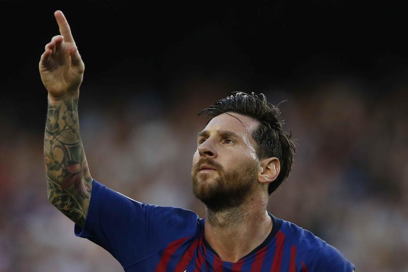 El argentino Lionel Messi festeja luego de anotar el primer tanto del Barcelona ante el PSV de Eindhoven, en un partido de la Liga de Campeones de Europa. (AP)