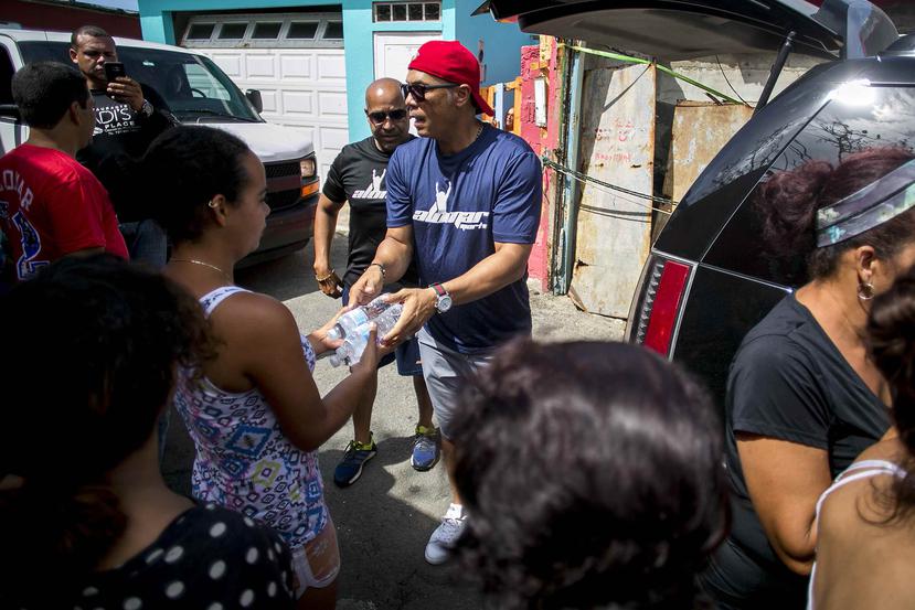Durante el recorrido por La Perla, Alomar ofreció a los residentes agua, arroz y camisetas.
